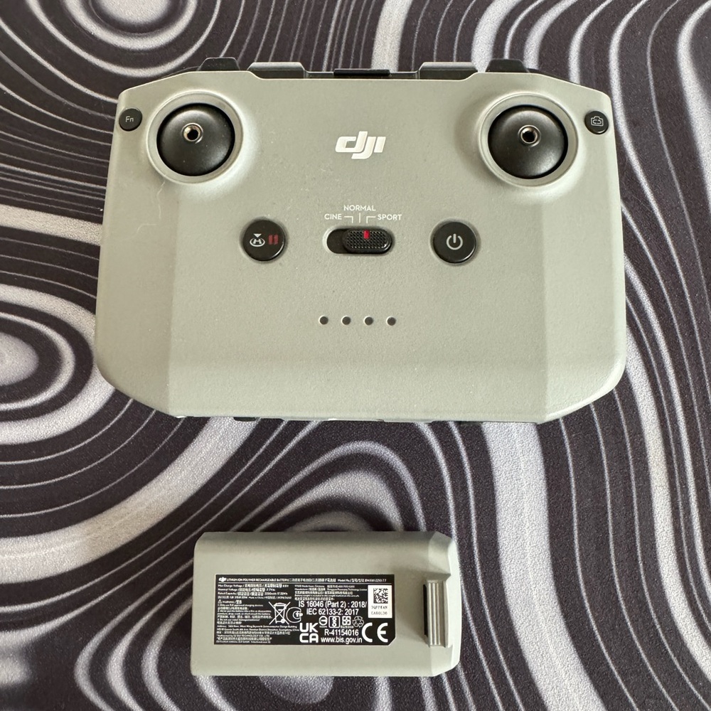 DJI remote controller with cables, DJI mini 2 battery.